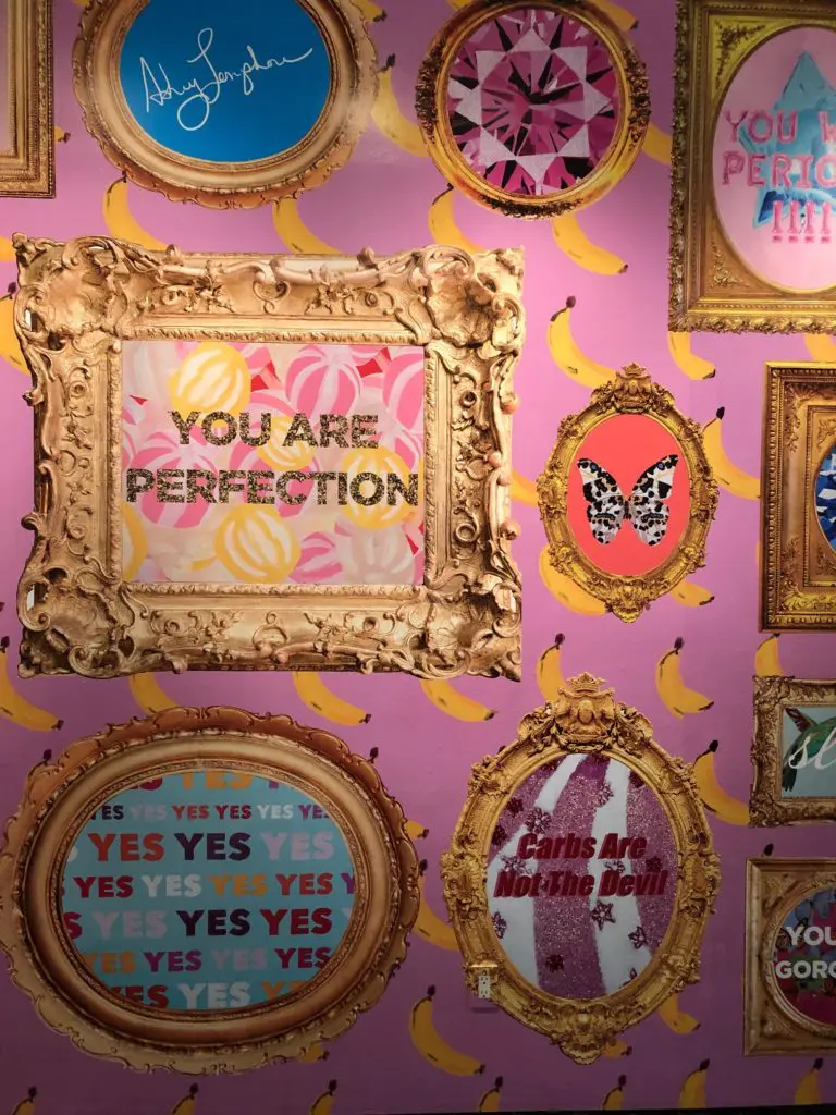 As the first official artist-in-residence at New York Fashion Week, Ashley Longshore created a pink wall of her words of wisdom. (Photo by Clifford Pugh)