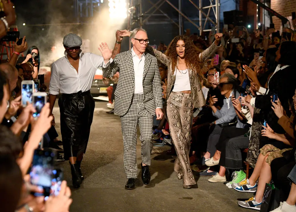 Tommy Hilfiger, middle, and Zendaya, right, take their runway bow. (Photo by Dave Kotinsky/Getty Images for Tommy Hilfiger)