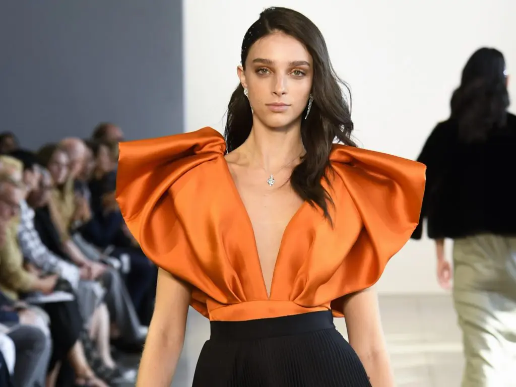 Bibhu Mohapatra tangerine silk barathea wing top with tulle and cotton pleated skirt;  Forevermark Artemis Collection by Bibhu and PMJ Jewels necklace and earrings. (Photo courtesy of Bibhu Mohapatra)