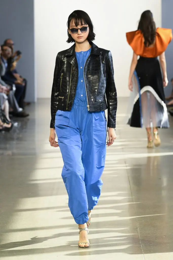 A loose-fitting Bibhu Mohapatra jumpsuit has a factory worker vibe for the women who wants to roll up her sleeves and get to work. It is worn under a black alligator jacket. (Photo courtesy of Bibhu Mohapatra)