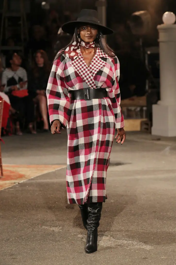 Tommy X Zendaya check coat, leather belt, polka dot neck tie, leather boots. (Photo courtesy of Tommy Hilfiger)
