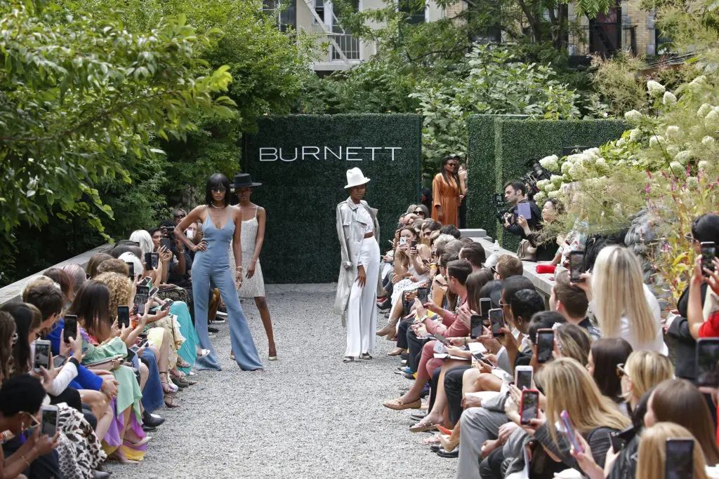At the end of the Burnett New York runway show, actress Damaris Lewis and models Flaviana Matata and  Dani Evans stood up and struck a runway pose. (Photo courtesy of Burnett New York)