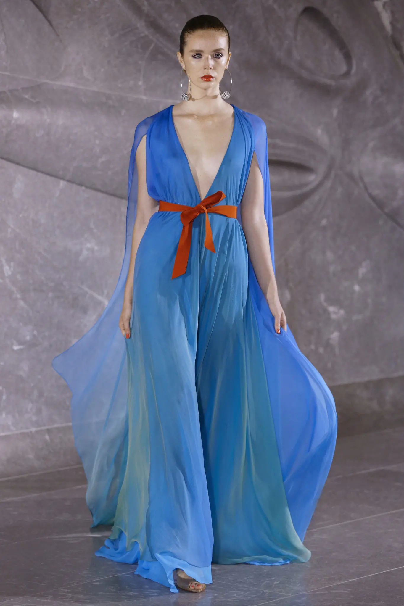 Naeem Khan V-neck draped chiffon gown with cape and belt details in turquoise to green degrede. (Photo by Dan Lecca)