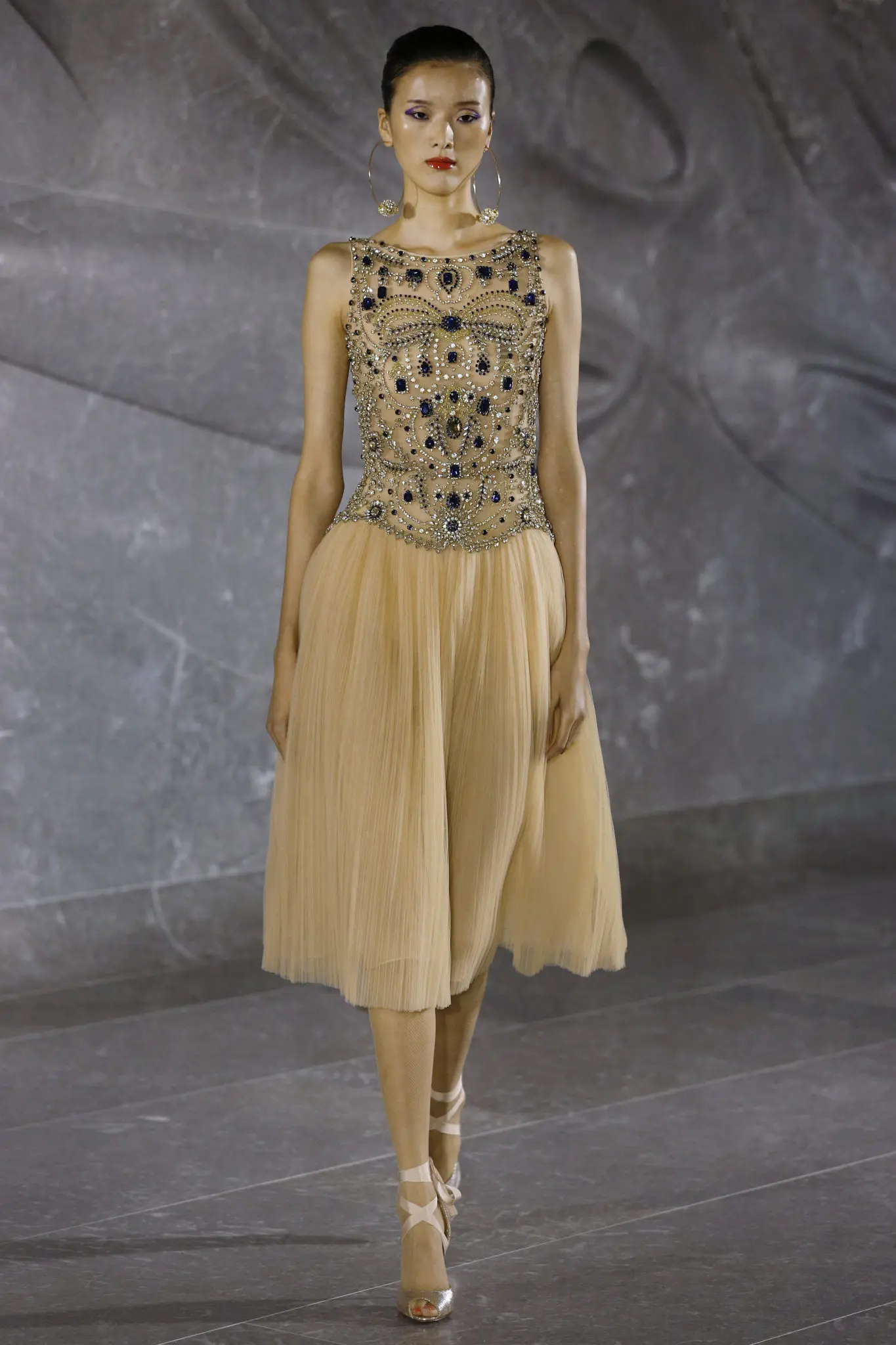 Naeem Khan sleeveless tea-length dress with jeweled bodice and pleated skirt. (Photo by Dan Lecca)