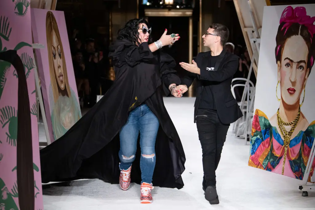 Christian Siriano and Ashley Longshore form a mutual admiration society as they walk the runway together at the end of his show at New York Fashion Week.(Photo by Luca Zanoni)

