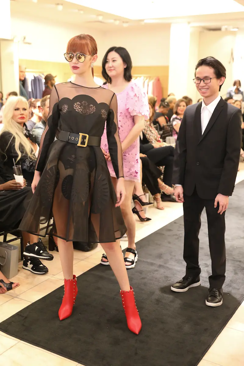 HCC model precedes Fashion Degisn Student honoree Jing Cao and Fashion Merchandising Student honoree Nathan Phan (Photo by Priscilla Dickson)