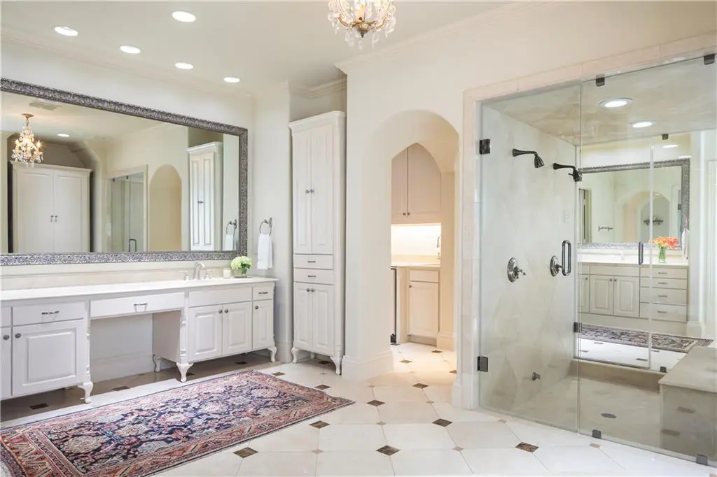 The master bath boasts his and hers closets and vanities. 