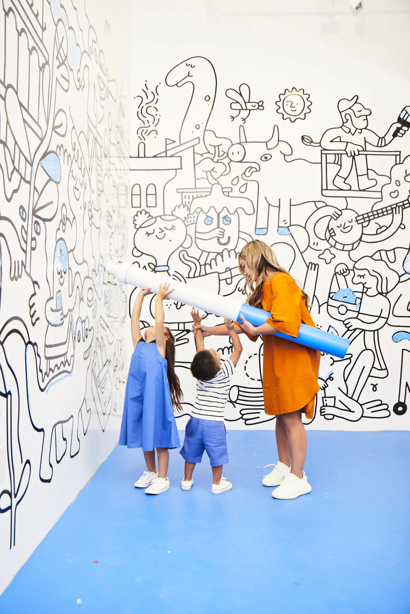 The "Color Me" space, created by artists Andrew Neyer and Andy J. Pizza, features large black-and-white murals that are colored in by guests using oversized, five-foot-long blue markers. (Photo by Cody Bess)