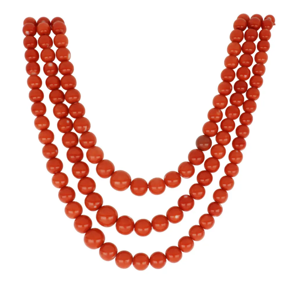 The triple strand of orange coral the perfect accompaniment for a navy top.