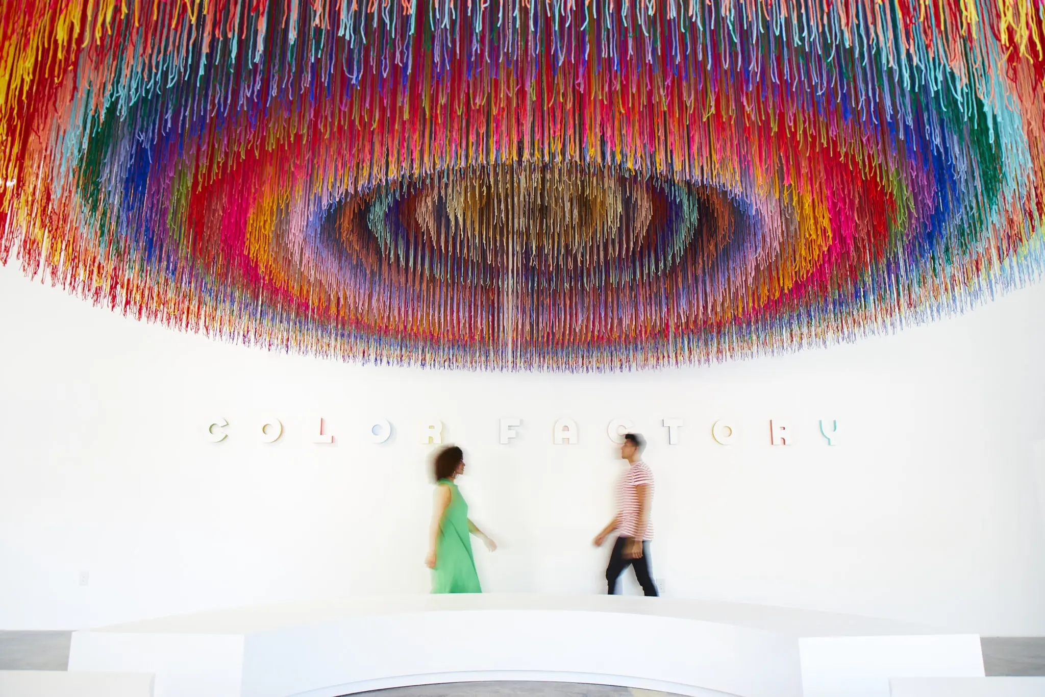 Guests enter through an oversized lobby that contains a multi-colored overhead circular mural made of yarn called "Thirty" because it incorporates all 30 shades the Color Factory associates with Houston. (Photo by Cody Bess)