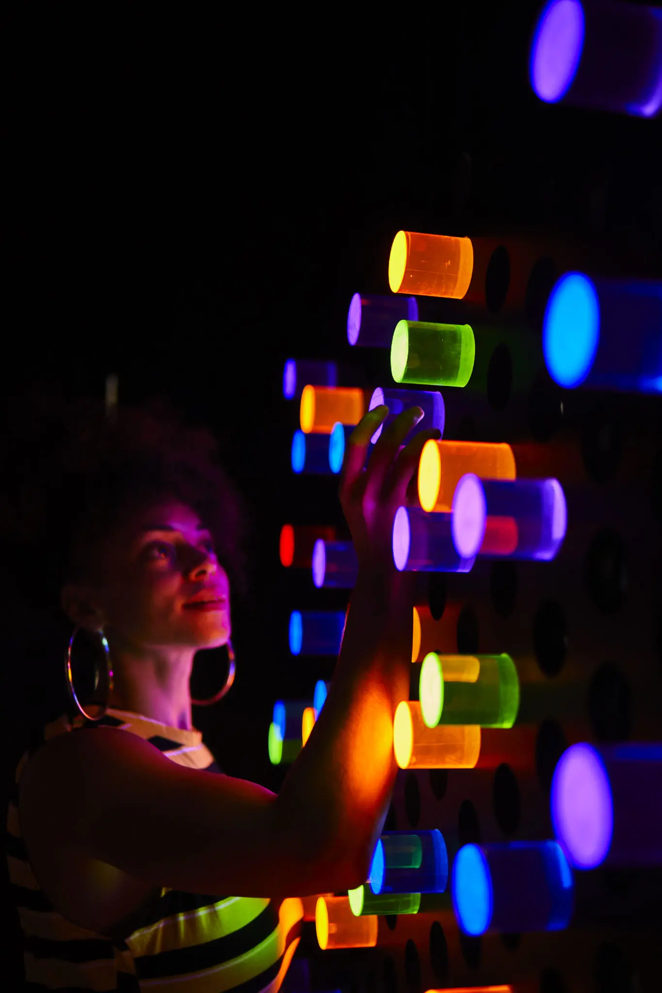 People didn't want to leave the "Night Bright" room, where they can rearrange lit-up plastic tubes on peg board walls to make whatever design they want. (Photo by Cody Bess)