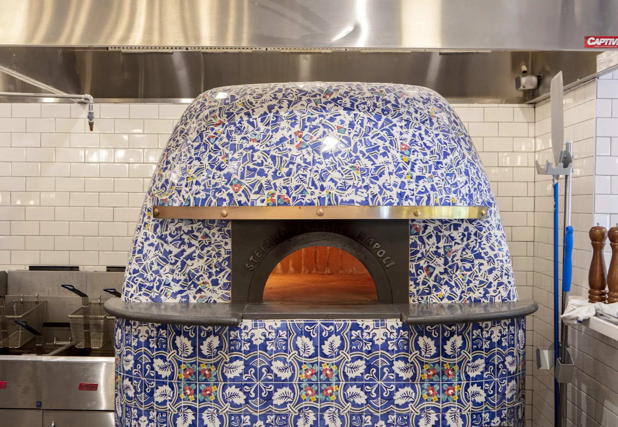 You can watch pizzas being made in this hand-tiled pizza oven. (Photo by Emily Loving)