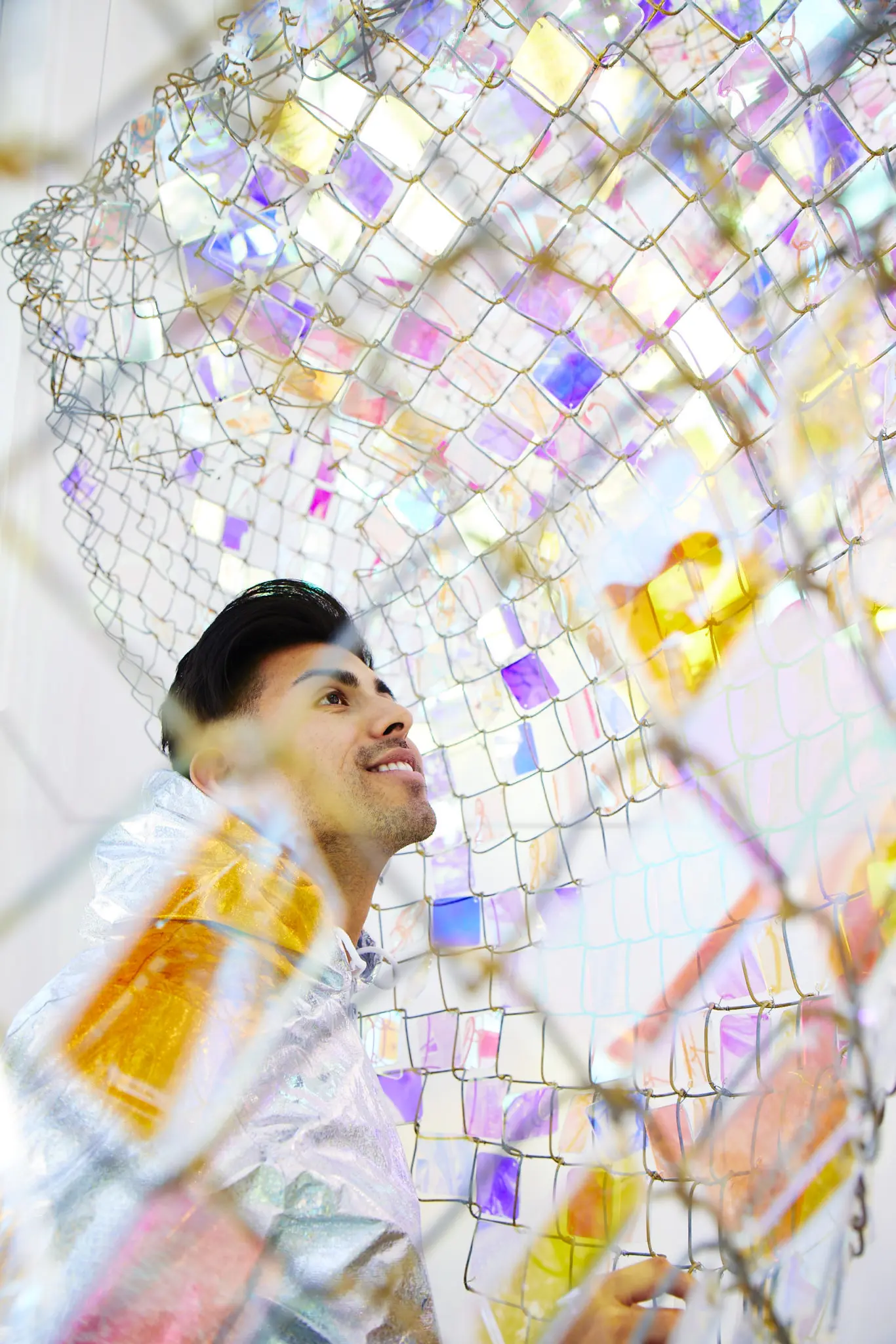 "Unwoven Light," made of chain-link fence and iridescent crystal squares, changes colors according to the natural light. (Photo by Cody Bess)
