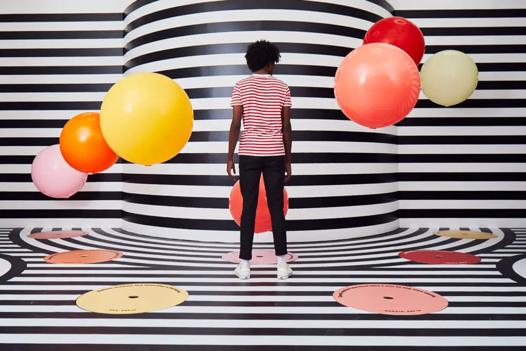 The Color Factory's "Thought Bubbles” is a black-and-white striped space populated with colorful floating balls that float up and down with blasts of high flow, low-pressure air. (Photo by Cody Bess)