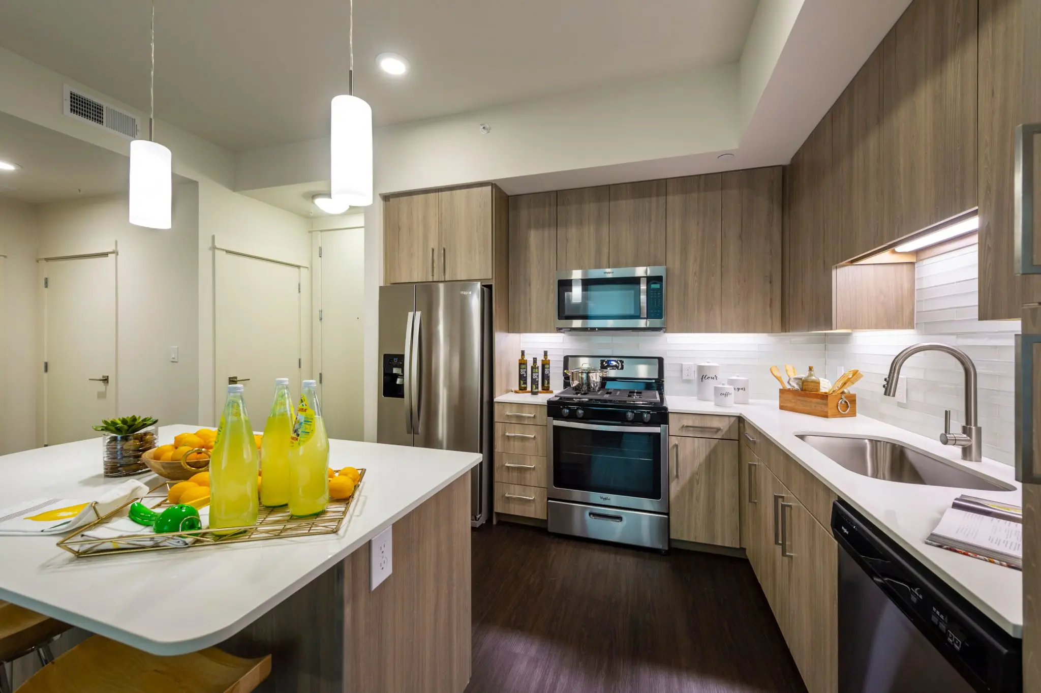 Every kitchen is outfitted with quartzite countertops with custom tiled glass backsplashes. 