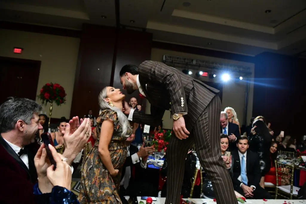 Kara McCullers gives hubby Lance a runway smooch at Una Notte in Italia. (Photo by Daniel Ortiz)