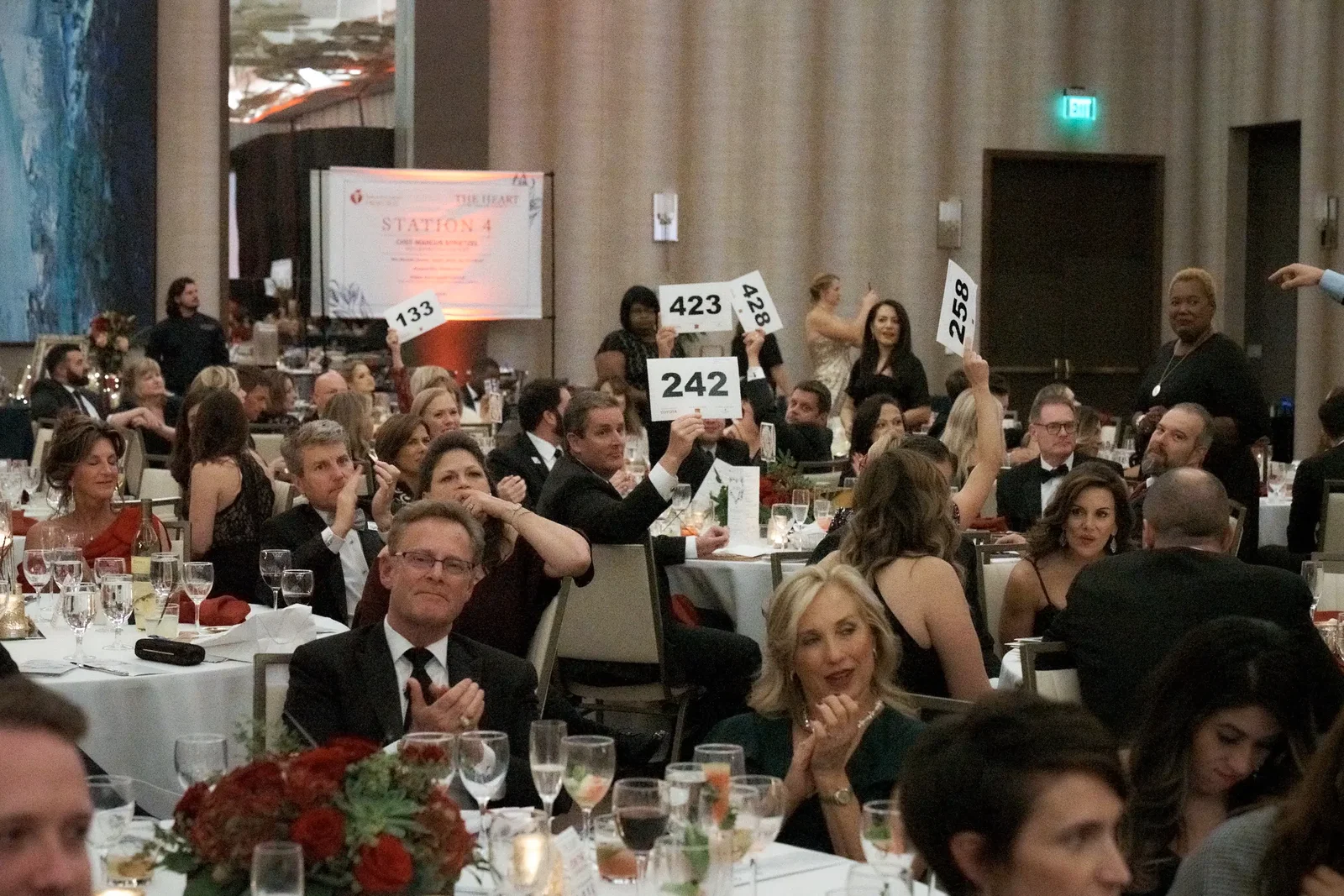 Guests excitedly bid on once-in-a-lifetime experiences.