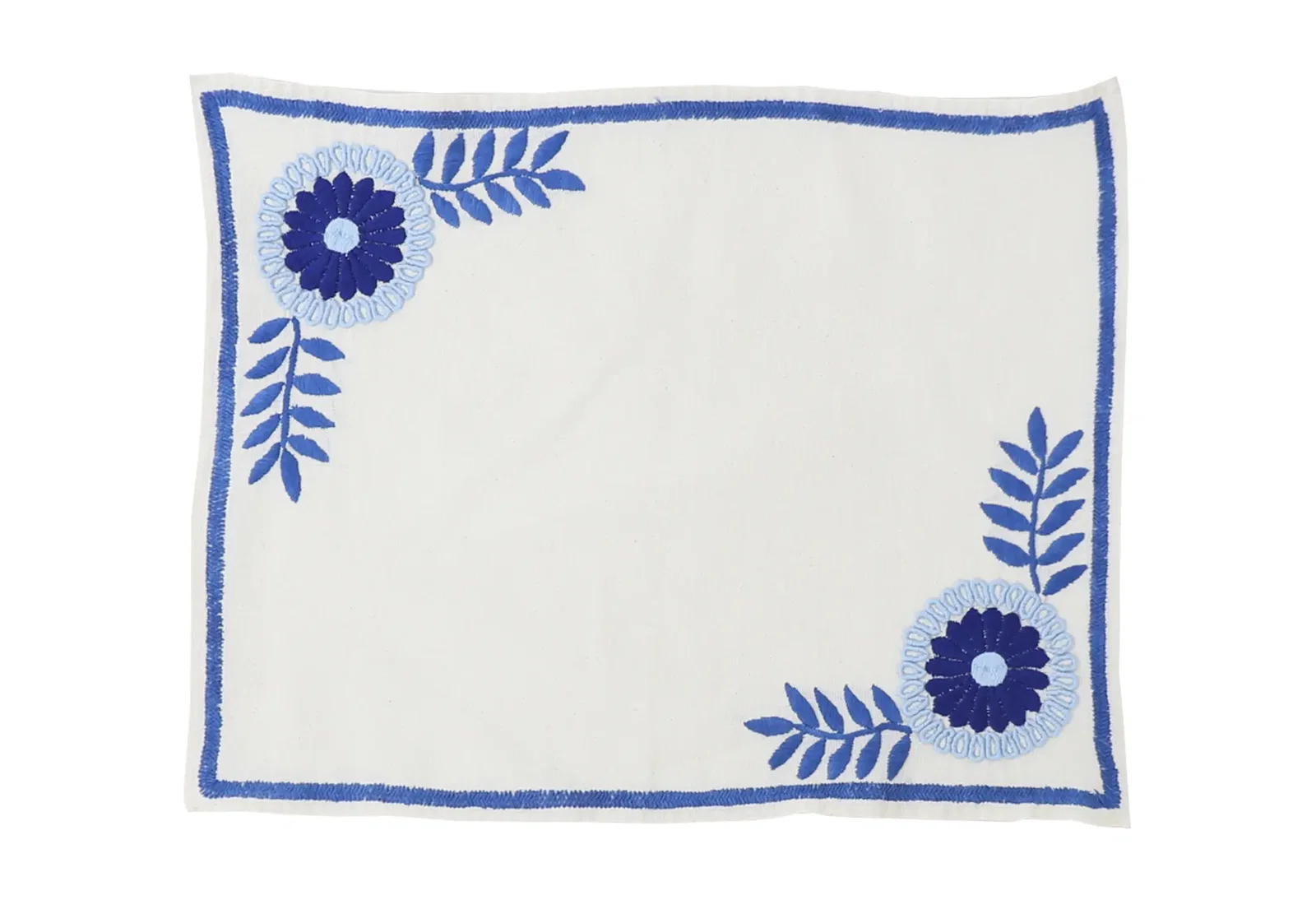 Mantel de Aguacatenango Azul hand-embroidered in Mexico with blue floral and vine designs on ivory linen.
