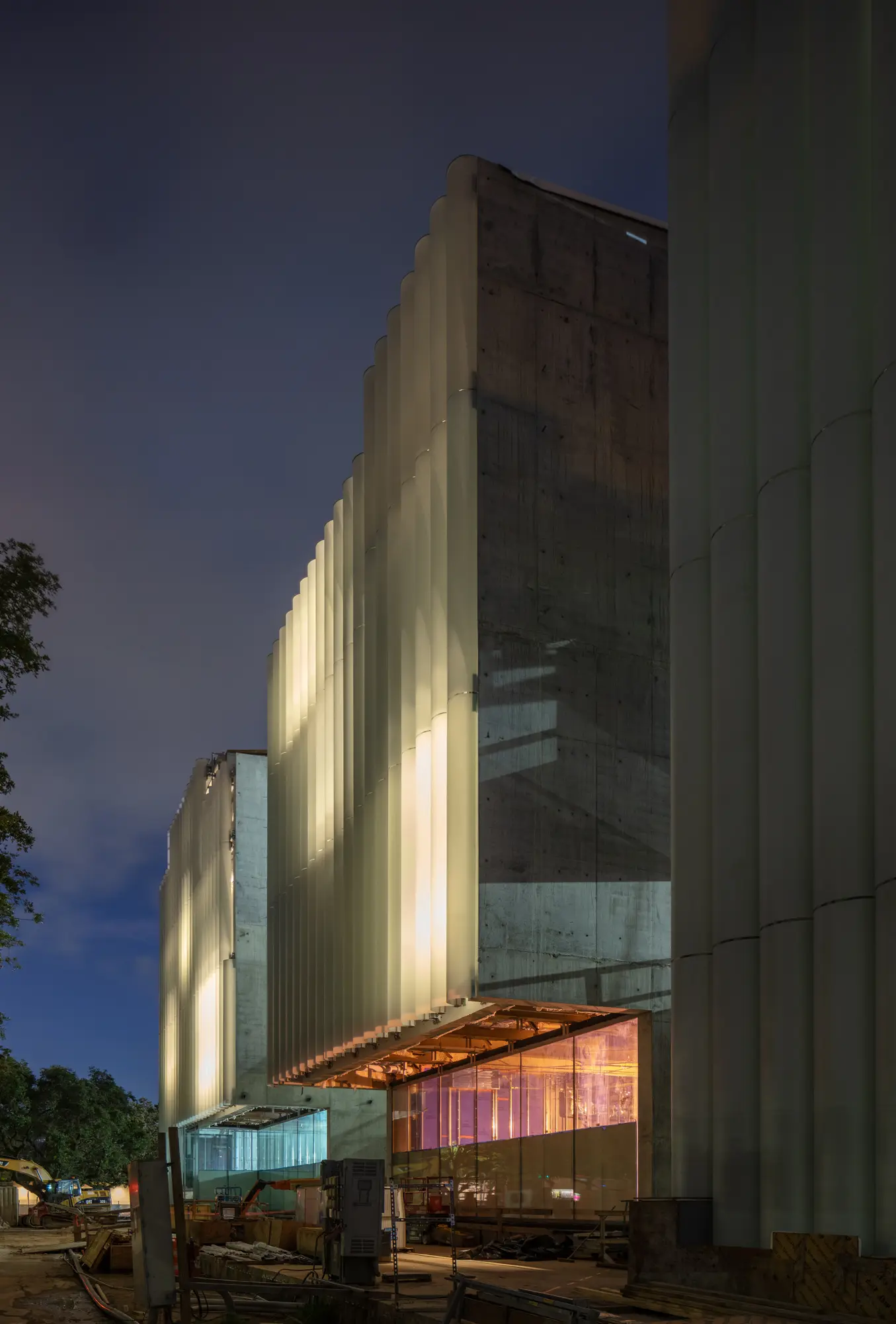 Diffused light glows from the glass tubing on the east facade of the MFAH Nancy and Rich Kinder Building, providing a contrasting serene element to the structure's  robust muscular stance. (Photo © Richard Barnes)