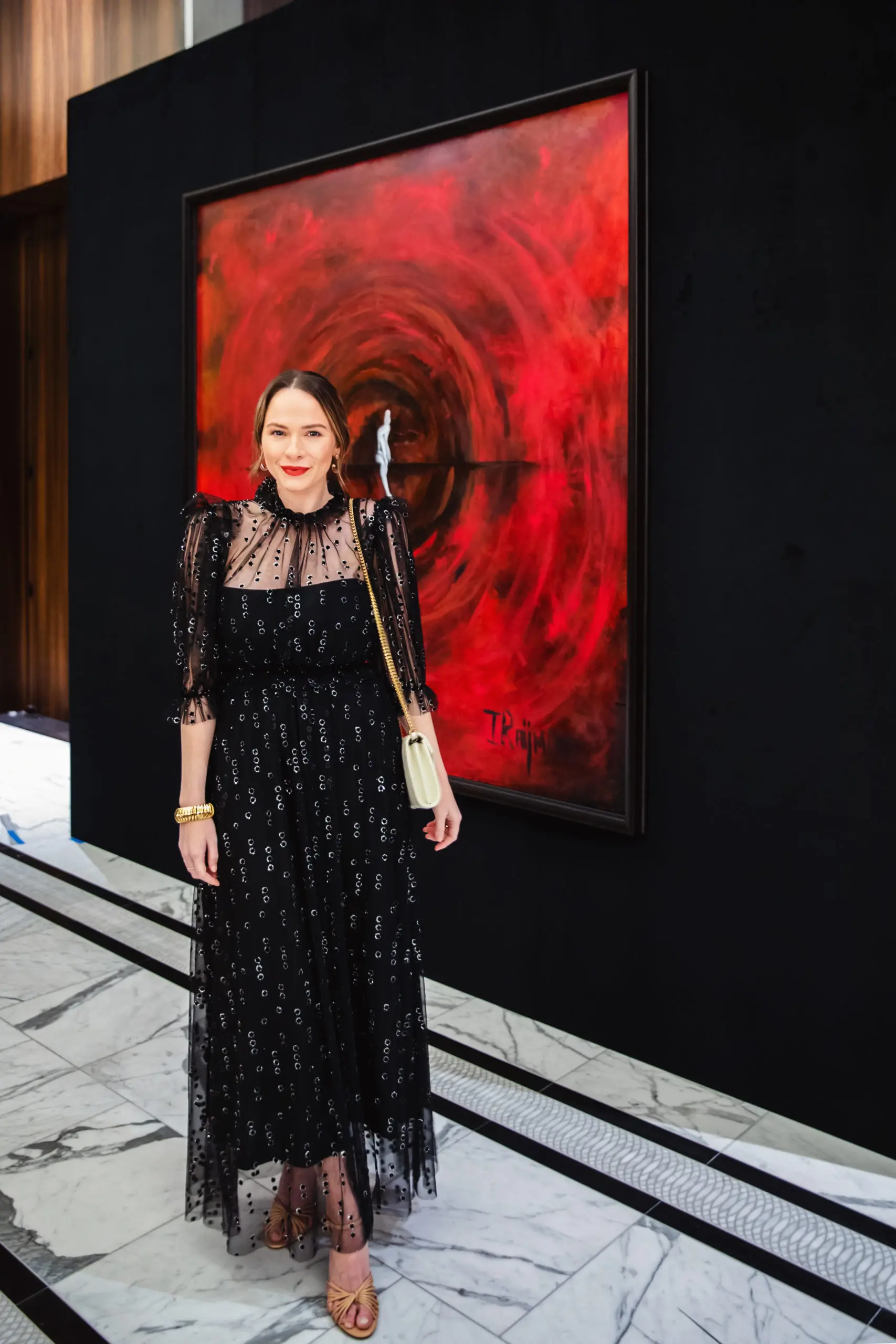 Hannah Swiggard in front of Dr. Isaac Raijman's painting (Photo by Mari Rice)
