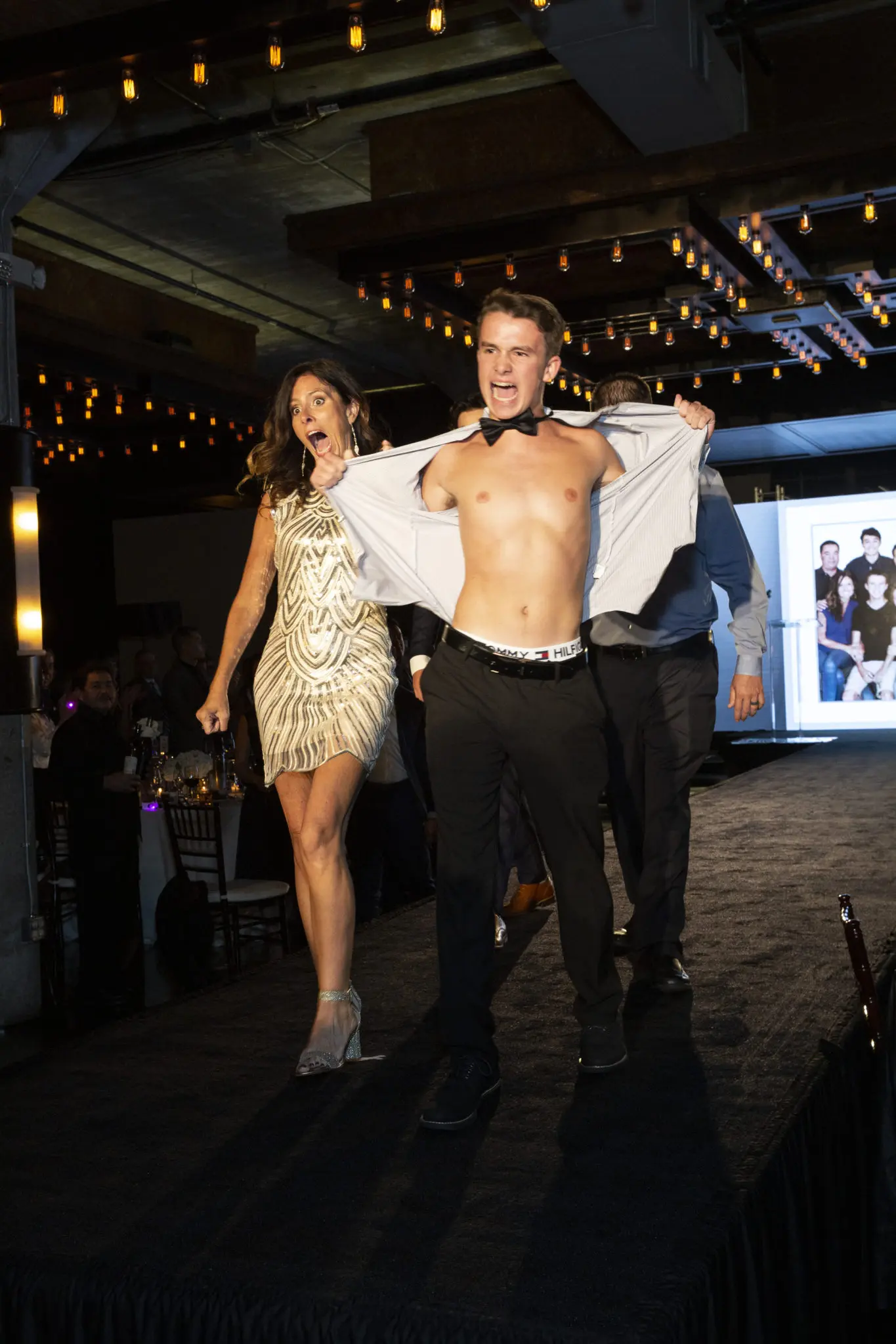 Cancer survivor Jake Phillips surprises everyone, including his mother Jaime Phillips, at Catwalk for a Cure. (Photo by Jenny Antill Clifton)
