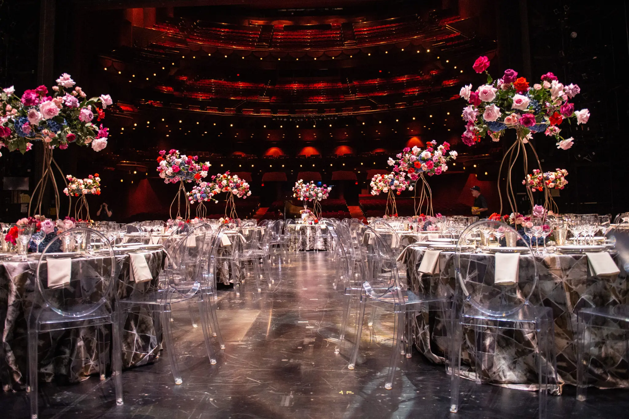 The tables on stage at Wortham Theater Center are set for the intimate dinner. (Photo by Wilson Parish)