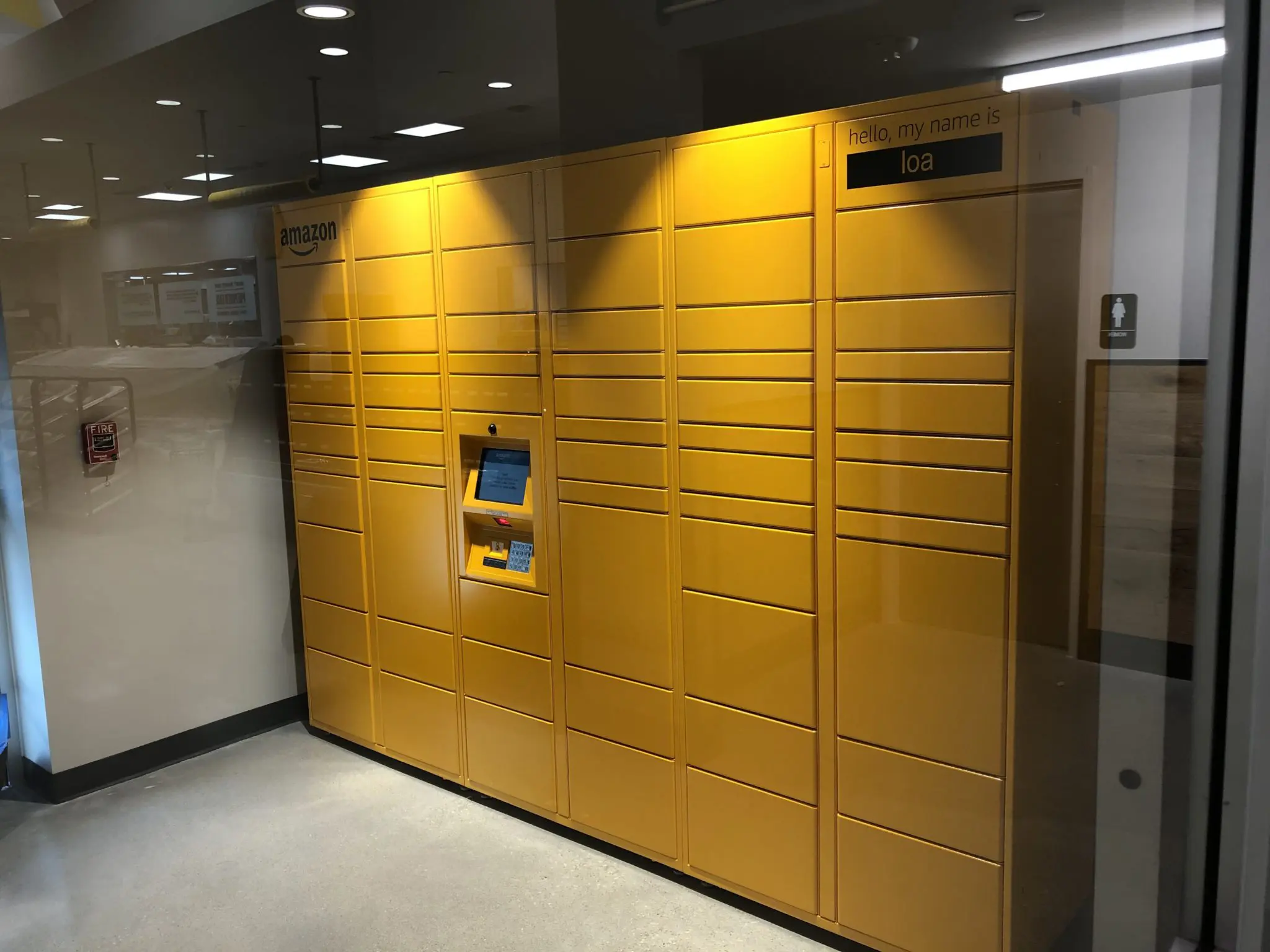 Adjacent to the checkout area is a large yellow Amazon Hub locker where packages can be delivered and returned. (Photo by Chad Miller)