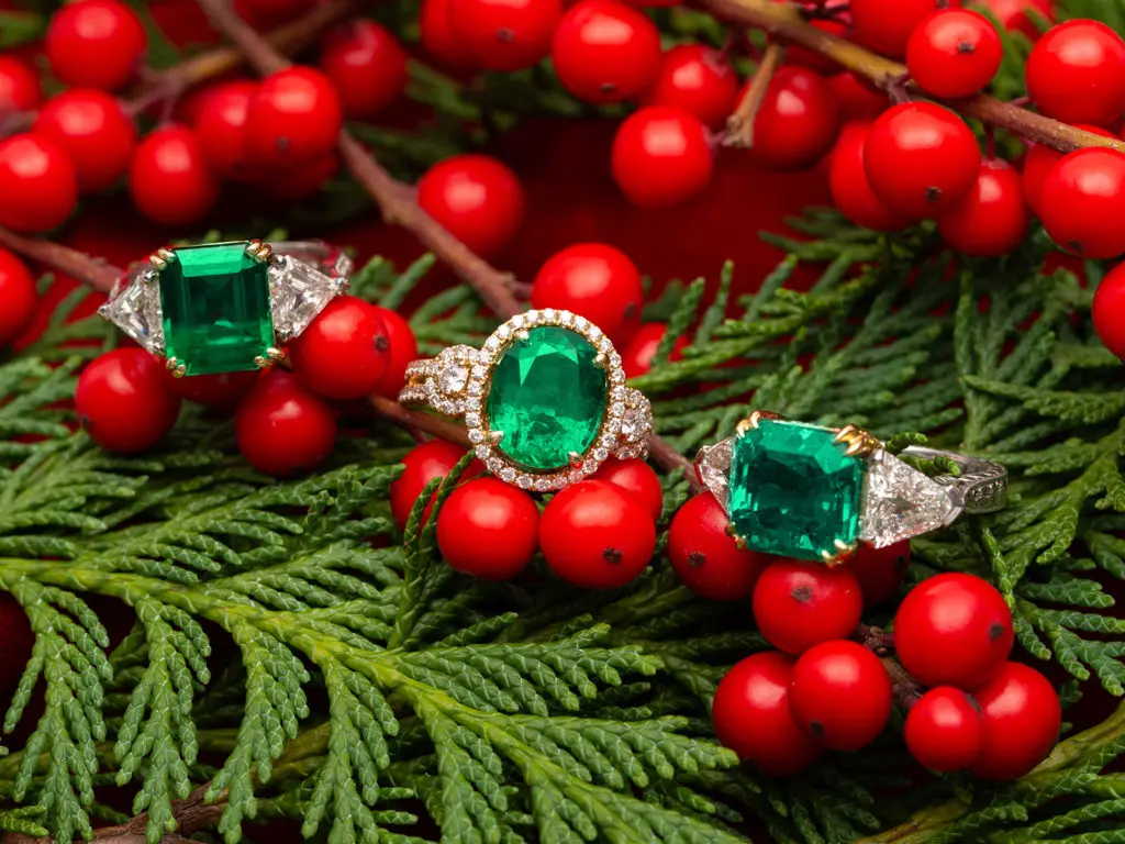 A selection of classic emerald and diamond rings; available in store