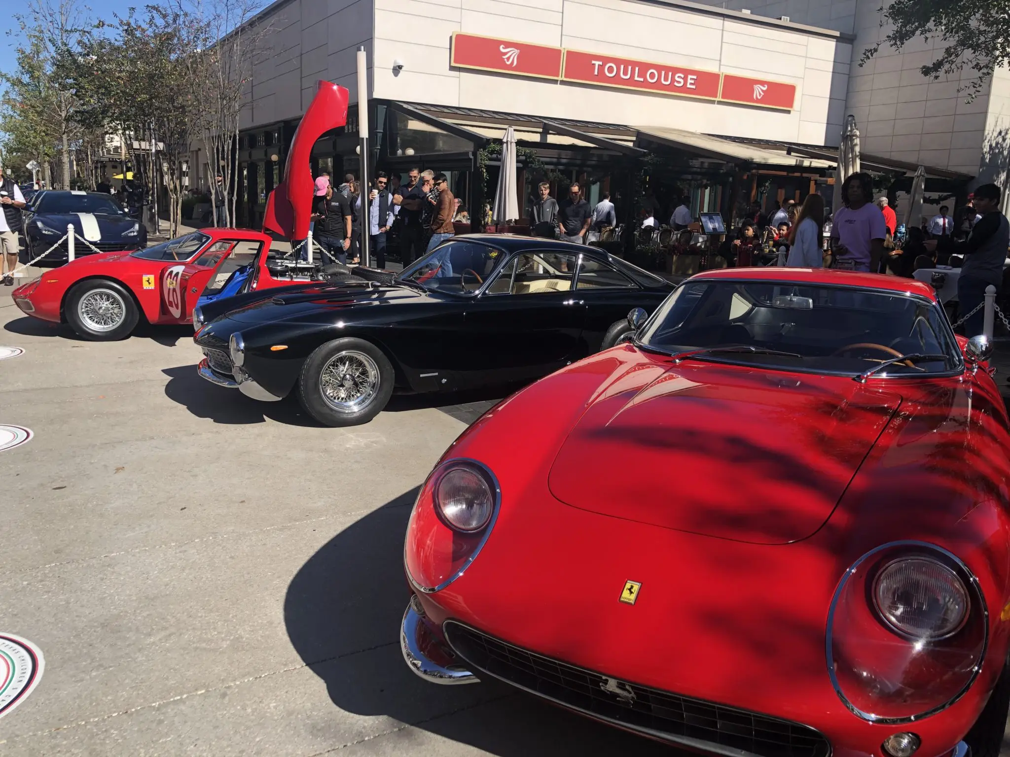 Three classic Ferraris parked in front of Toulouse with one valued at $20 million (Photo by Shelby Hodge)