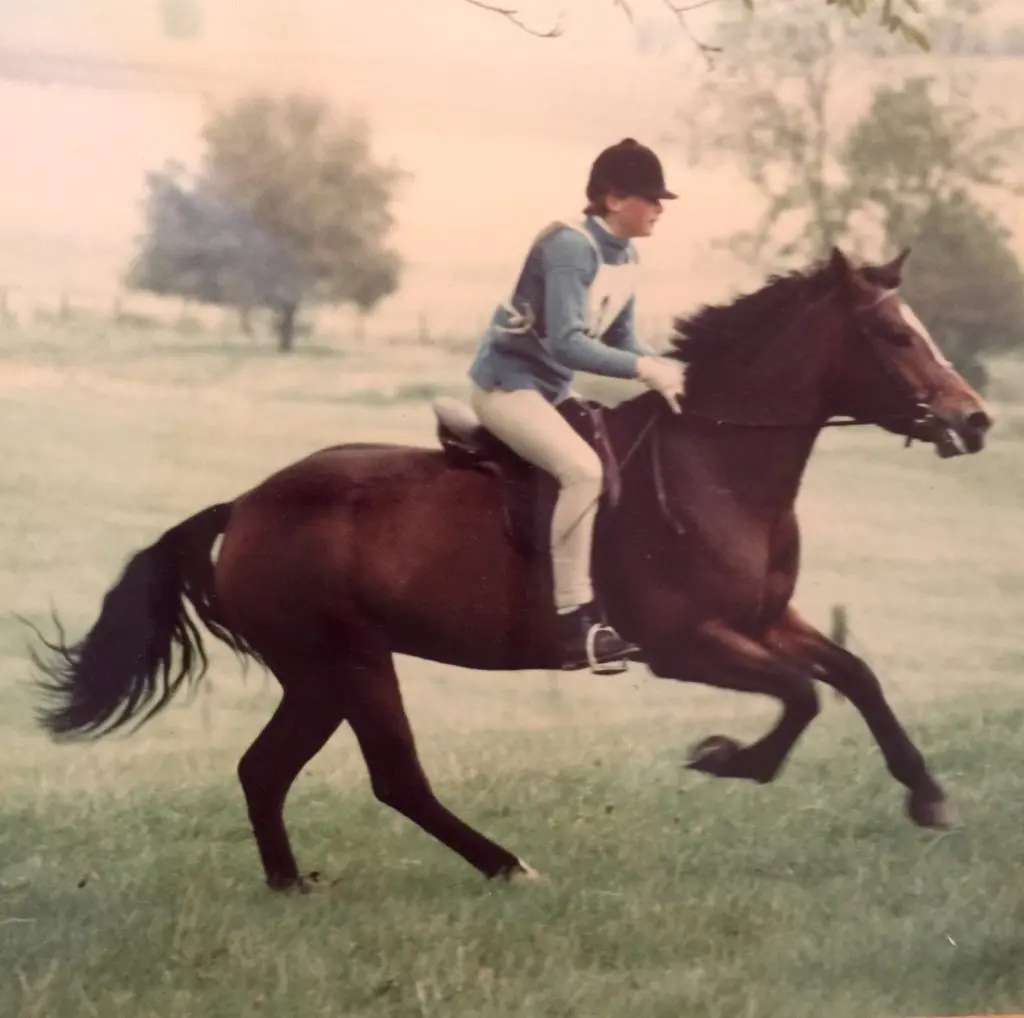Barker as a young woman confidently sits upon an equine.