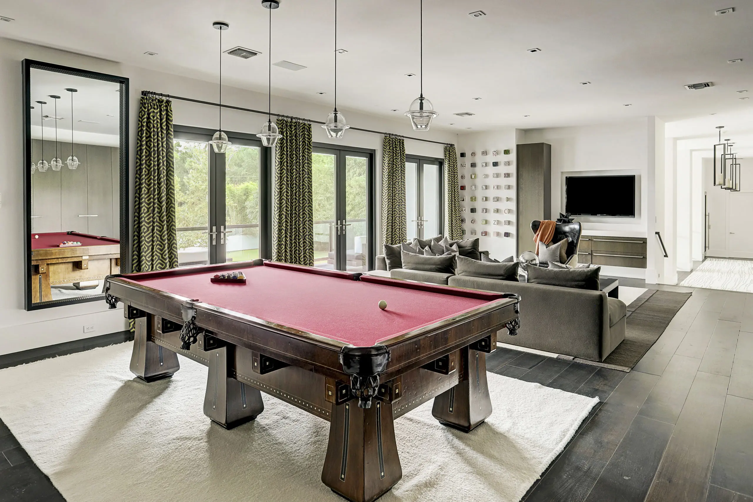 The raised playroom features hardwoods, ample storage for games and toys, and an extensive covered balcony.  (Photo by TK Images)