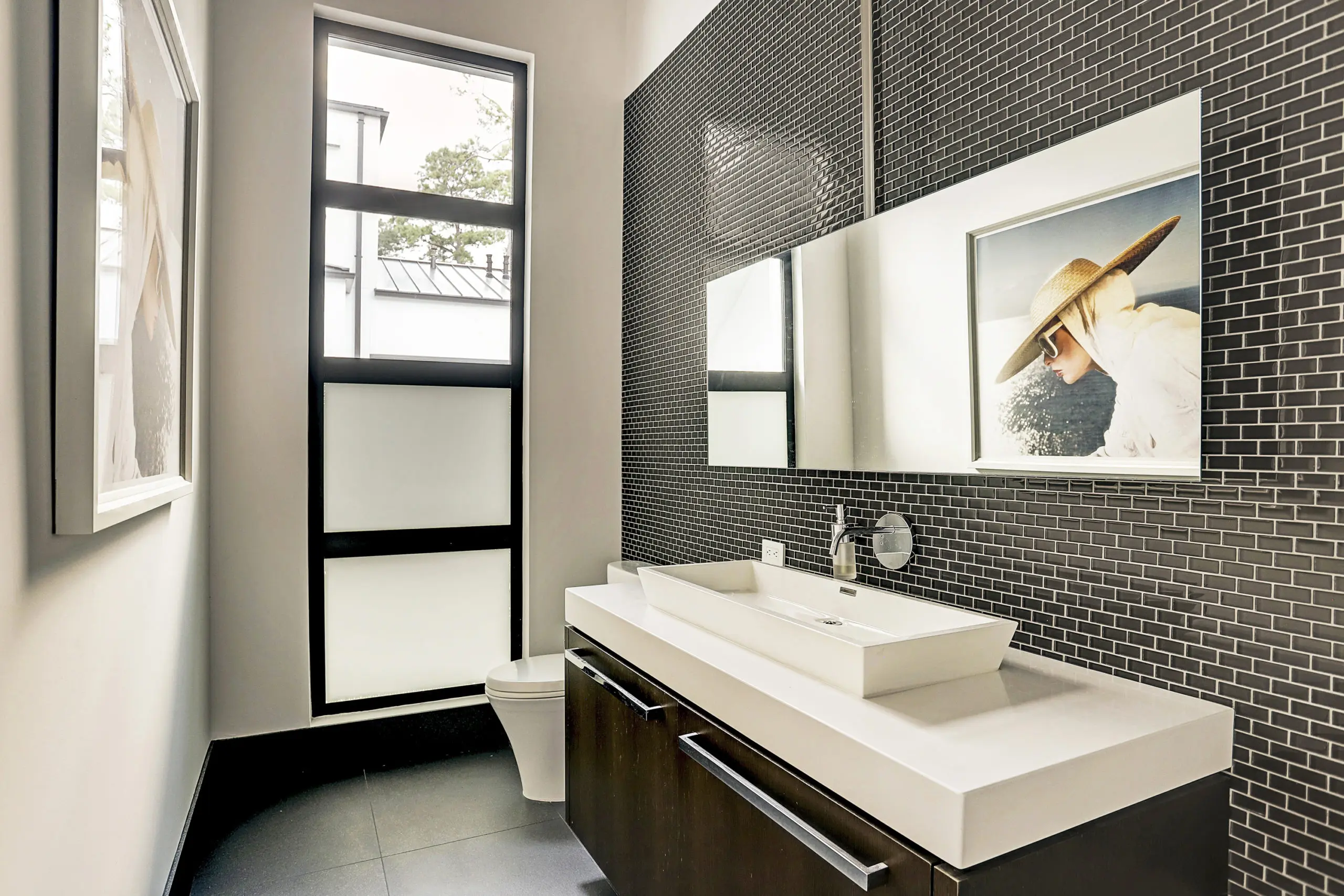 The pool bath features tilework and an oversized vanity with absolute white okite countertop and vessel.  (Photo by TK Images)