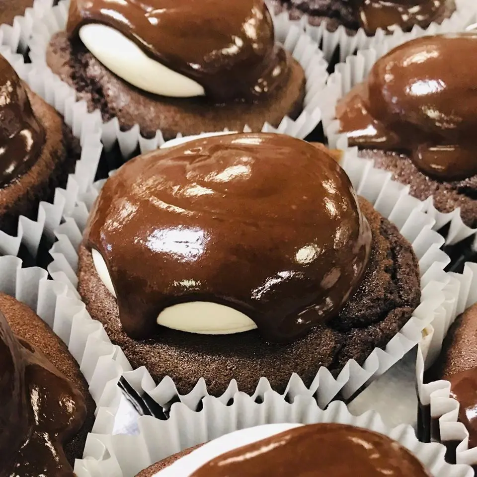 Chocolate cupcakes filled with a vanilla cream, iced with vanilla “unbuttercream” and coated in chocolate ganache show the strength of Unrefined's treats.