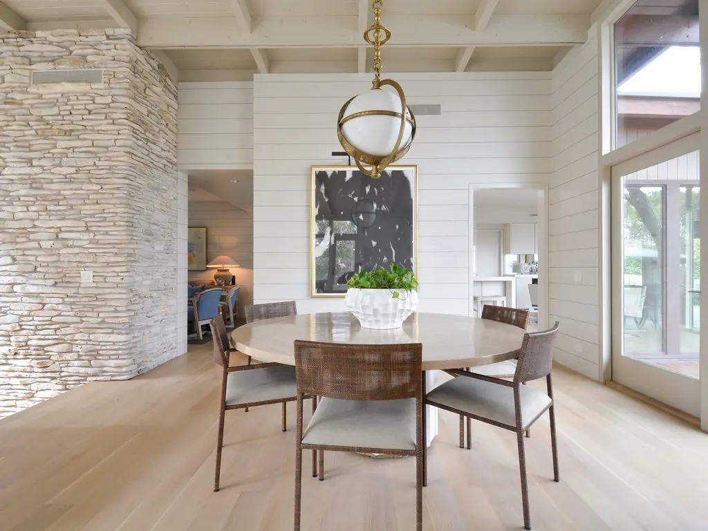 The painting by Houston artist McKay Otto provides a focal point in the dining area.
