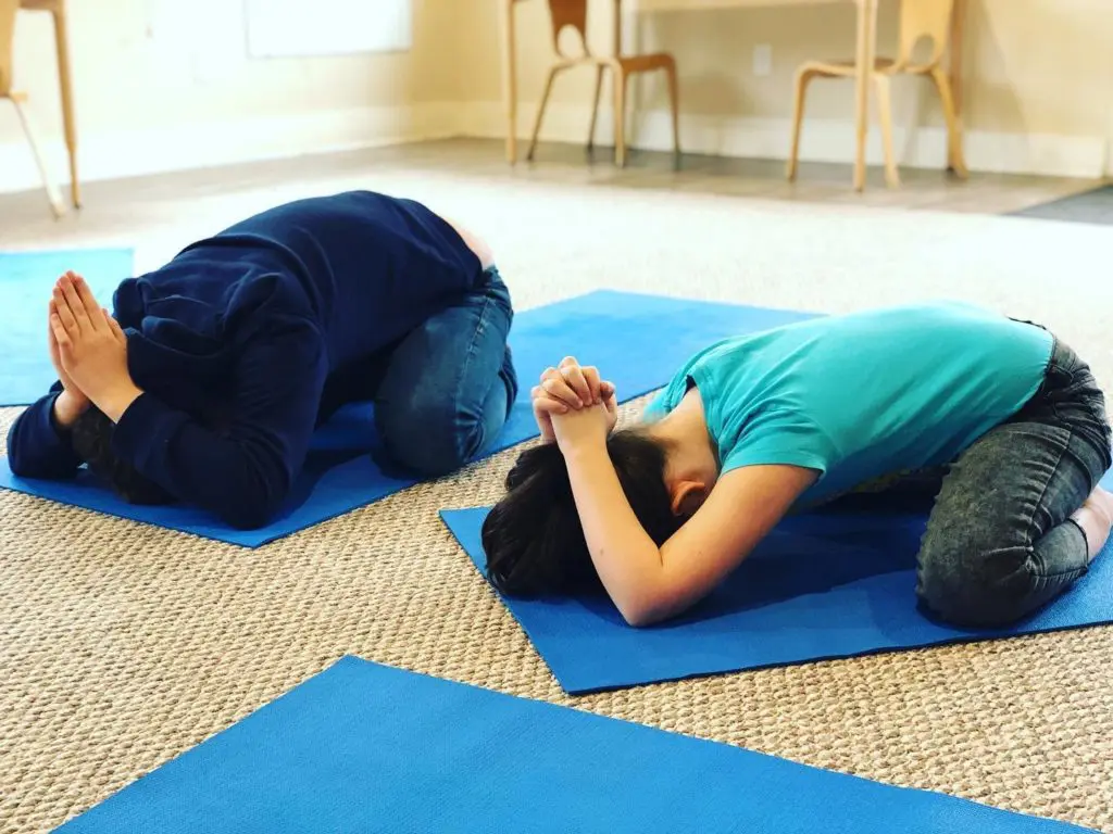 Kids enjoying some downtime in a yoga class.