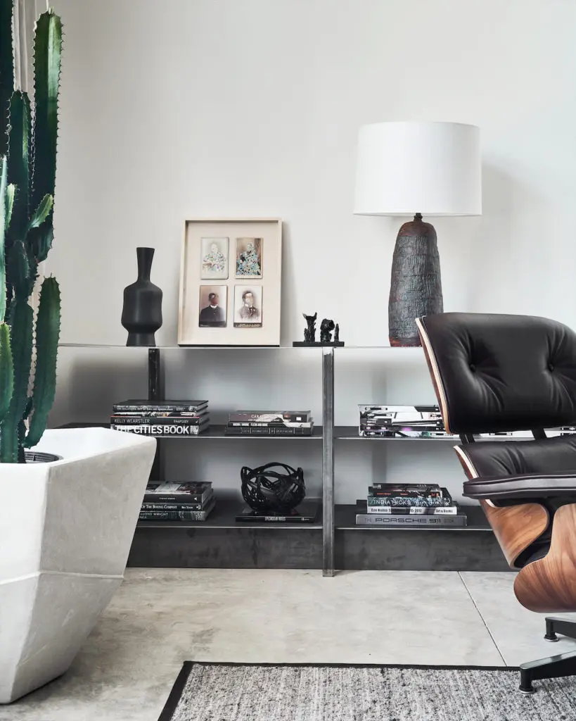 Eames lounge chair. Raw-steel shelves of Chad Dorsey’s design. Vintage lamp. (Photo by Stephen Karlisch)