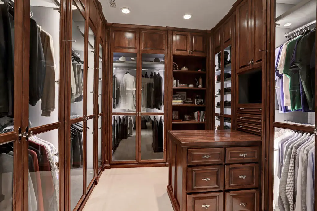 Shades of a British menswear boutique in the master closet at 8830 Stable Crest Blvd. 