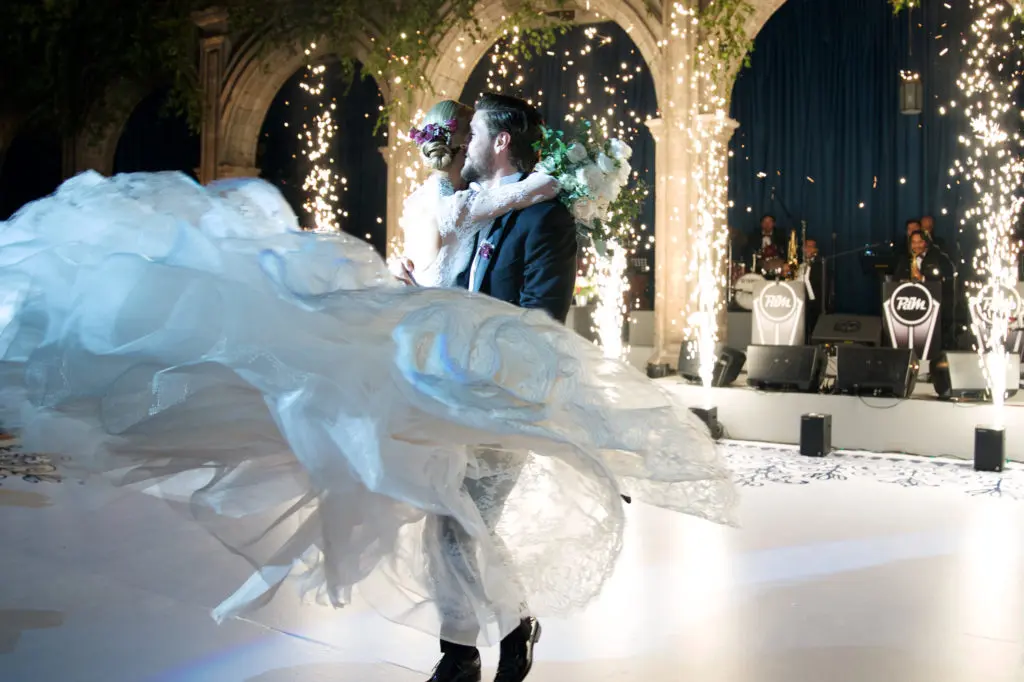 Mr. and Mrs. Carlos Gómez del Campo Neme celebrating at their wedding reception in Mexico City's Colegio de San Ignacio de Loyola Vizcaínas. (Photo by Graciela Ubando)