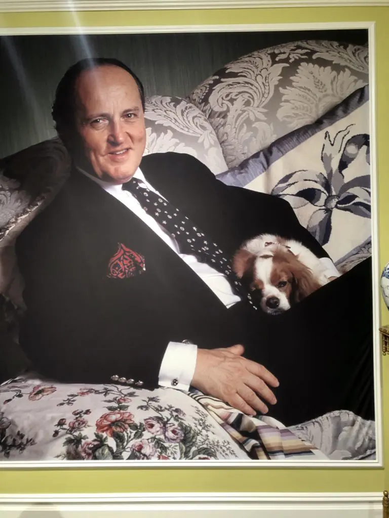 A portrait of Buatta and one of his beloved Cavalier King Charles Spaniels beamed down over the exhibition.  (Photo by Lacelliese King)
