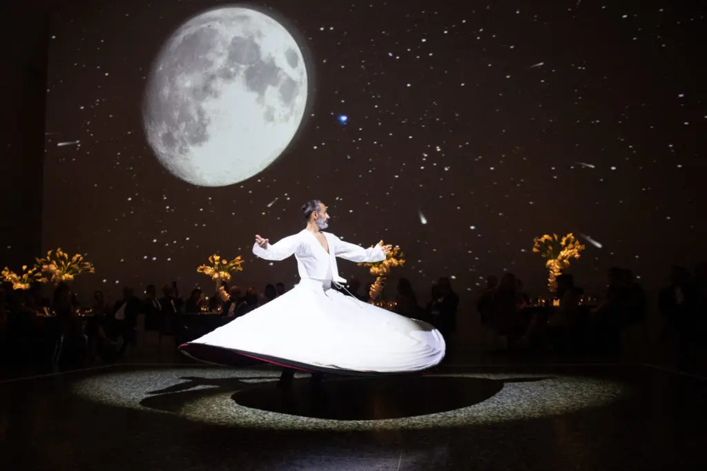 Ziya Azazi, Dervish in Progress, whirls across the floor of the Museum of Fine Arts, Houston's Cullinan Hall during the Art of the Islamic Worlds gala. (Photo by Wilson Parish)