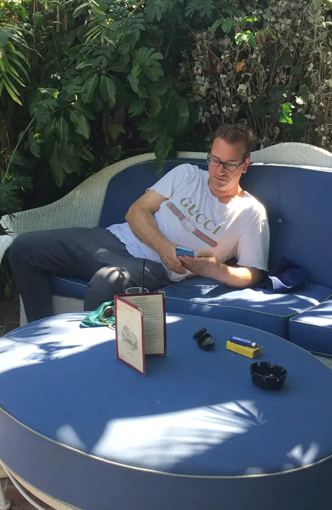 Pre-exhibition, artist headliner Michael Bevilacqua lounges by Chateau Marmont's pool, famous for celeb sightings.