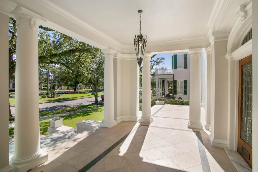 A sweeping front porch welcomes guests to 18  Audubon Place.