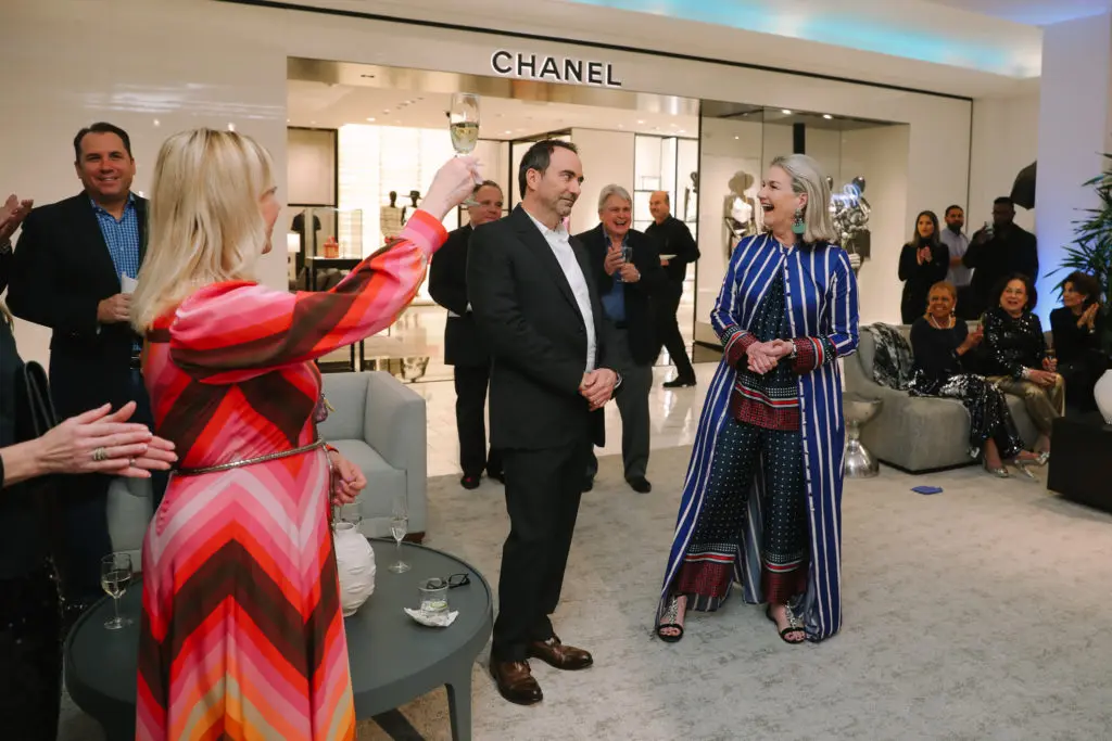 Courtnay Tartt Elias toasts PaperCity's Jim Kastleman and Holly Moore during the PaperCity 25th anniversary celebration held in early February at Neiman Marcus. (Photo by Johnny Than)