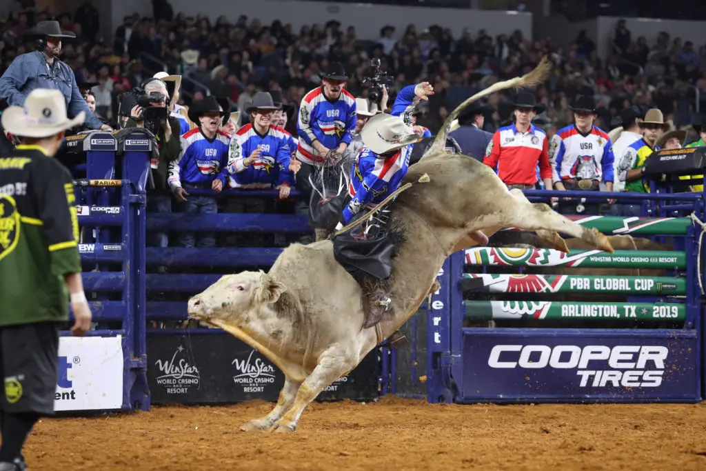 Cody Nance rides McCoy Ranches's Blue Crush for 87 during the second round of the Arlington PBR Global Cup. (Photo by Andy Watson)