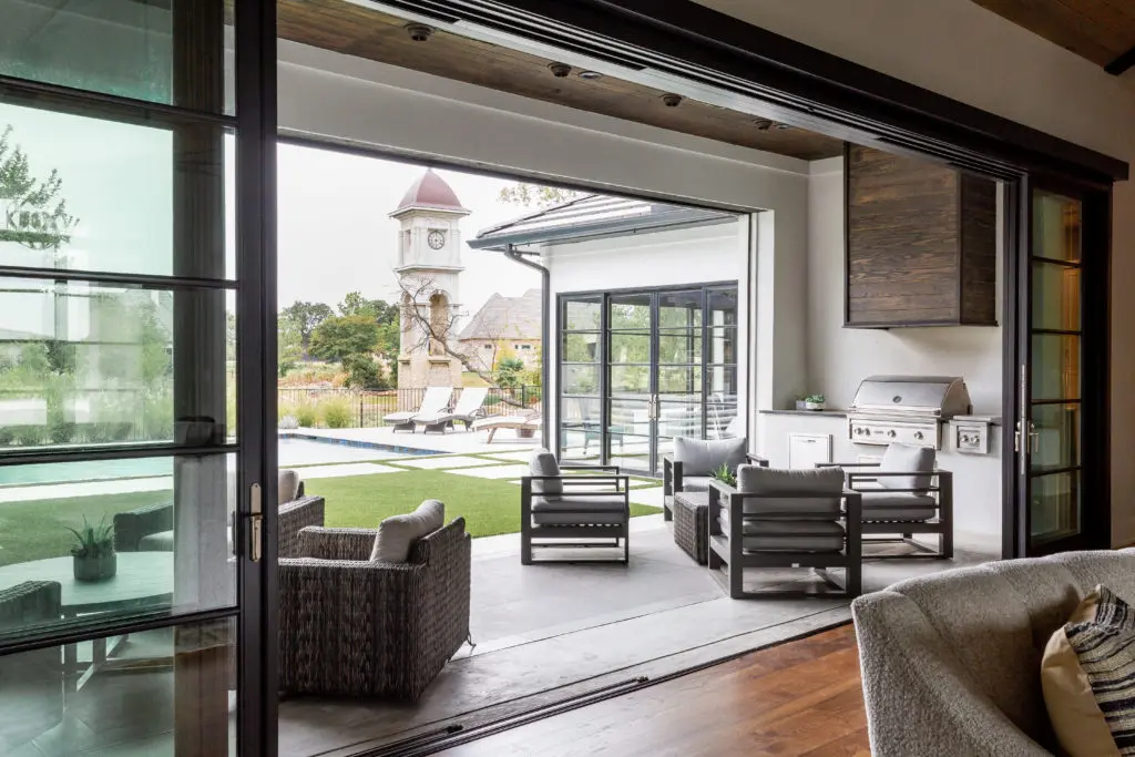 Outdoor furnishings from Rattana and Globalviews  invite indoor/outdoor living through the open glass wall. (Photo by Jen Burner)