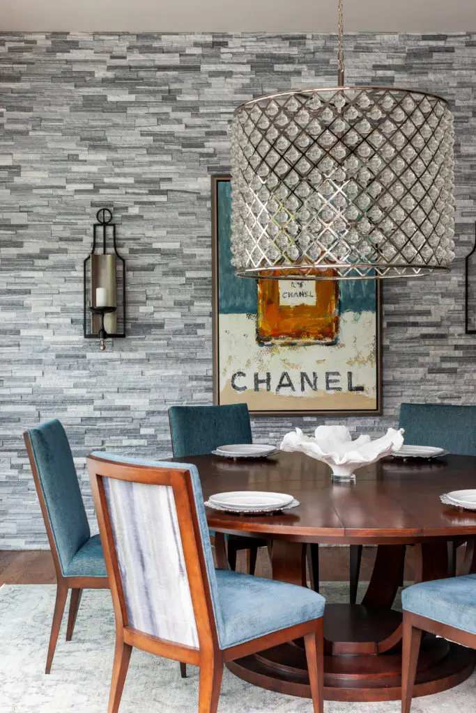 The mood of the formal dining room chairs and expandable table in walnut finish is lightened by the hand-knot traditional rug.  (Photo by Jen Burner)