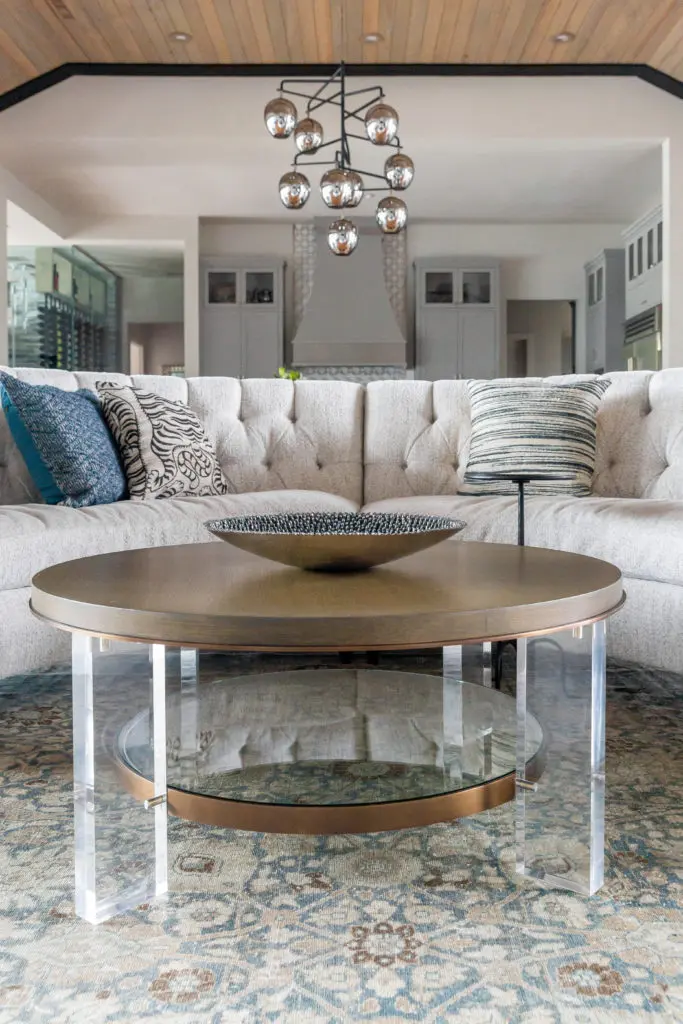 The curved sectional sofa, custom from Ambella, in the living room wraps around the sitting area creating an intimate space for wine by the fire. (Photo by Jen Burner)