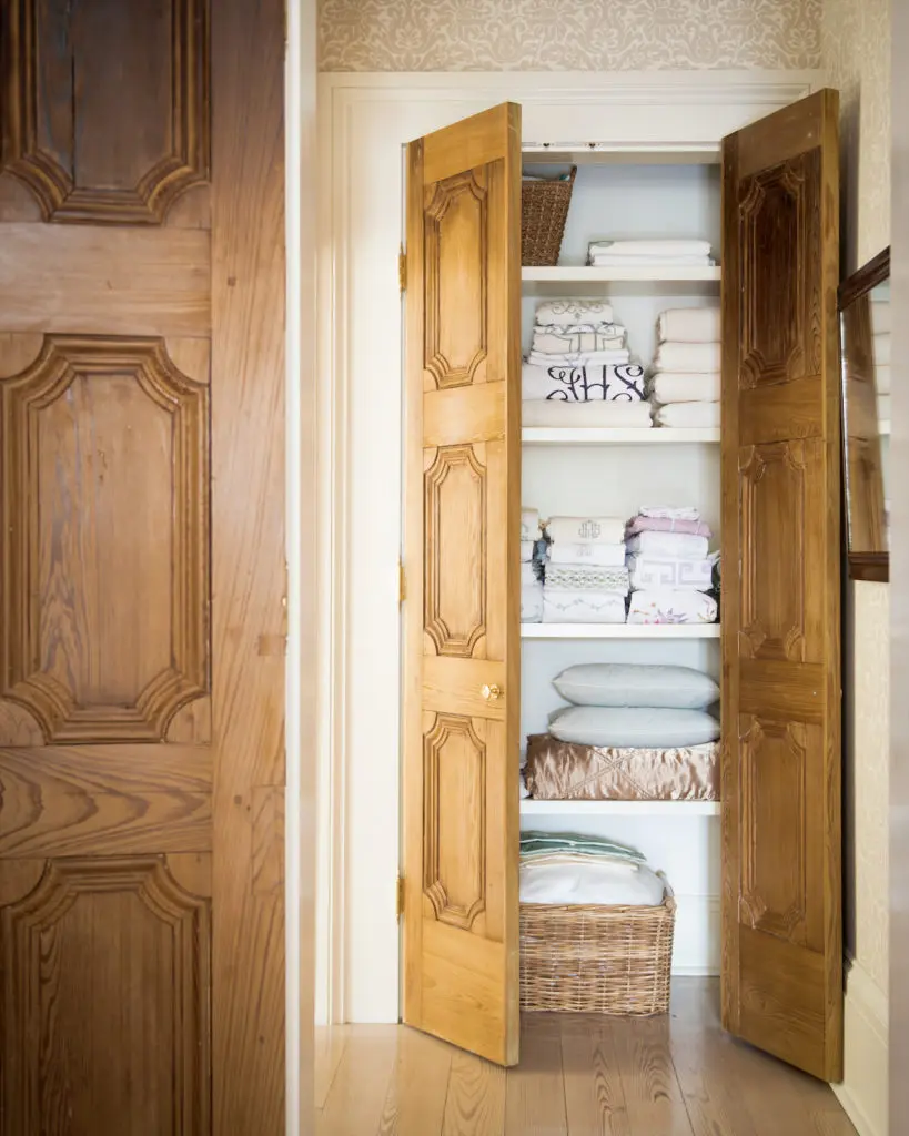 A cupboard with antique doors holds Leontine Linens.  (Photo by Paul Costello)