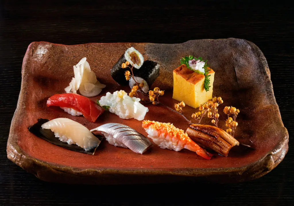 A selection of edomae sushi at Tei-An in Dallas. Top row, kanpyu maki (salted gourd roll) and tamago (sweet omelet). Second row, zuke maguro (tuna) and yari ika (squid). Bottom row, hirame kobujime (flounder), kohada, kuruma ebi (shrimp), and anago (sea eel). (Photo by Kevin Marple)