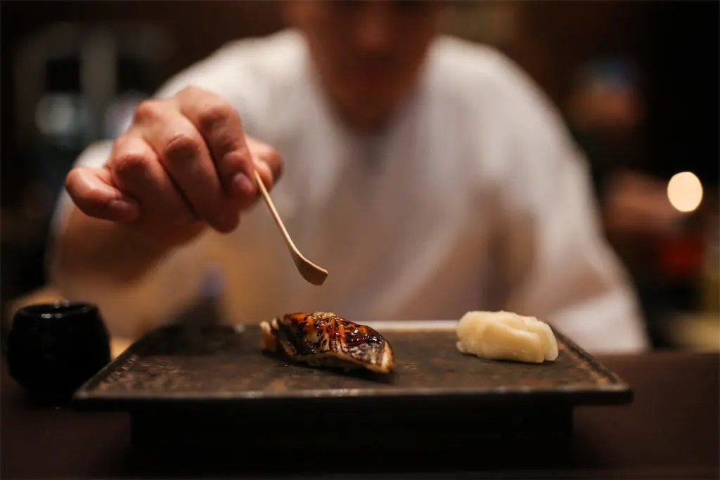 Chef Jorge Dionicio presents anago (sea eel), one of his 21 courses in his edomae menu at Namo.